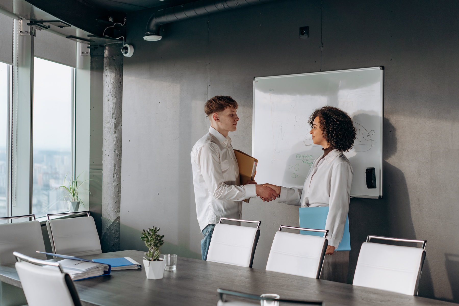 Business People Shaking Hand in a Conference Room